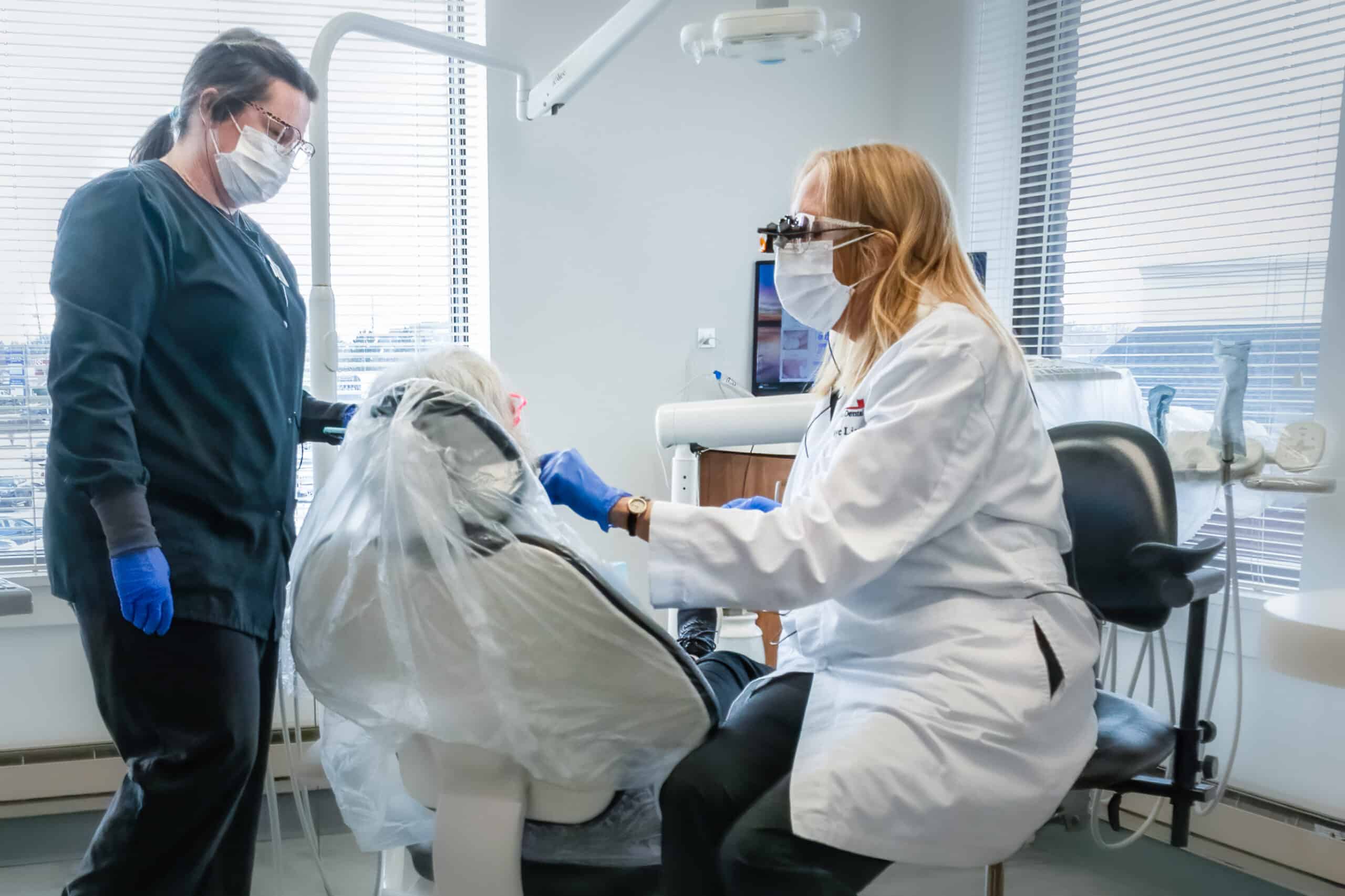 Dr. Faye Licata and dental assistant with patient